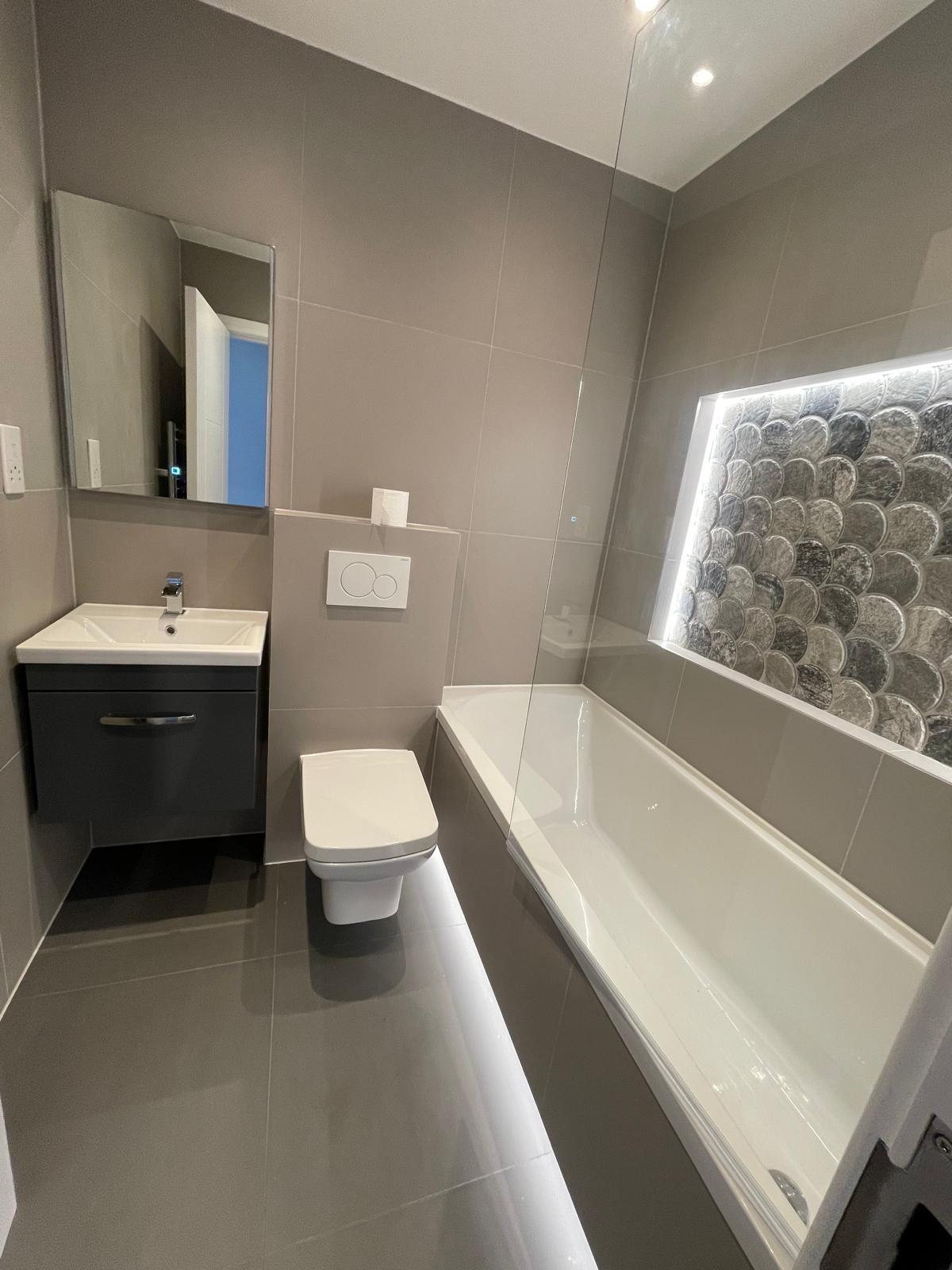 Bathroom renovation featuring new tiles and contemporary fixtures