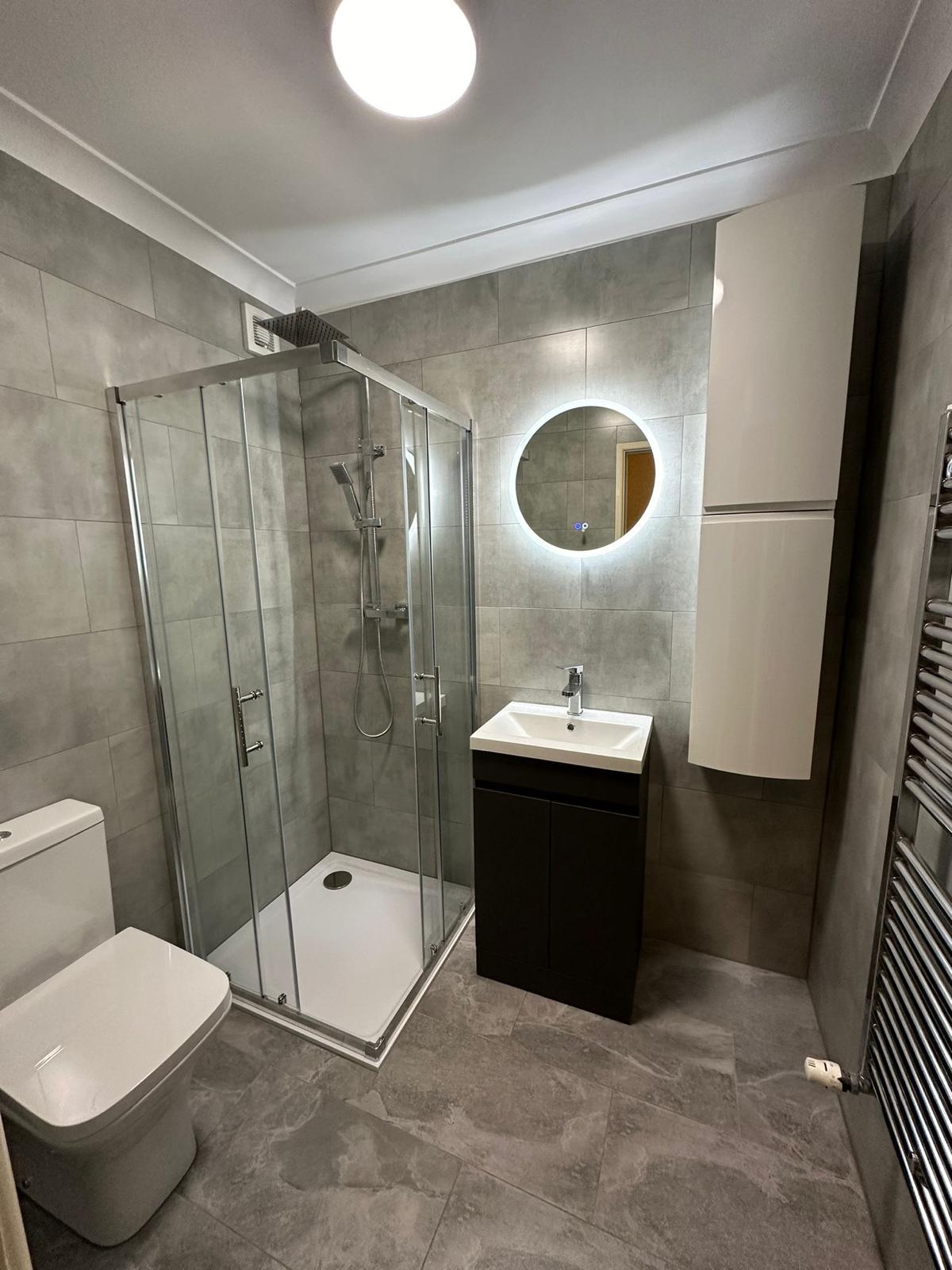 Bathroom renovation featuring new tiles and contemporary fixtures