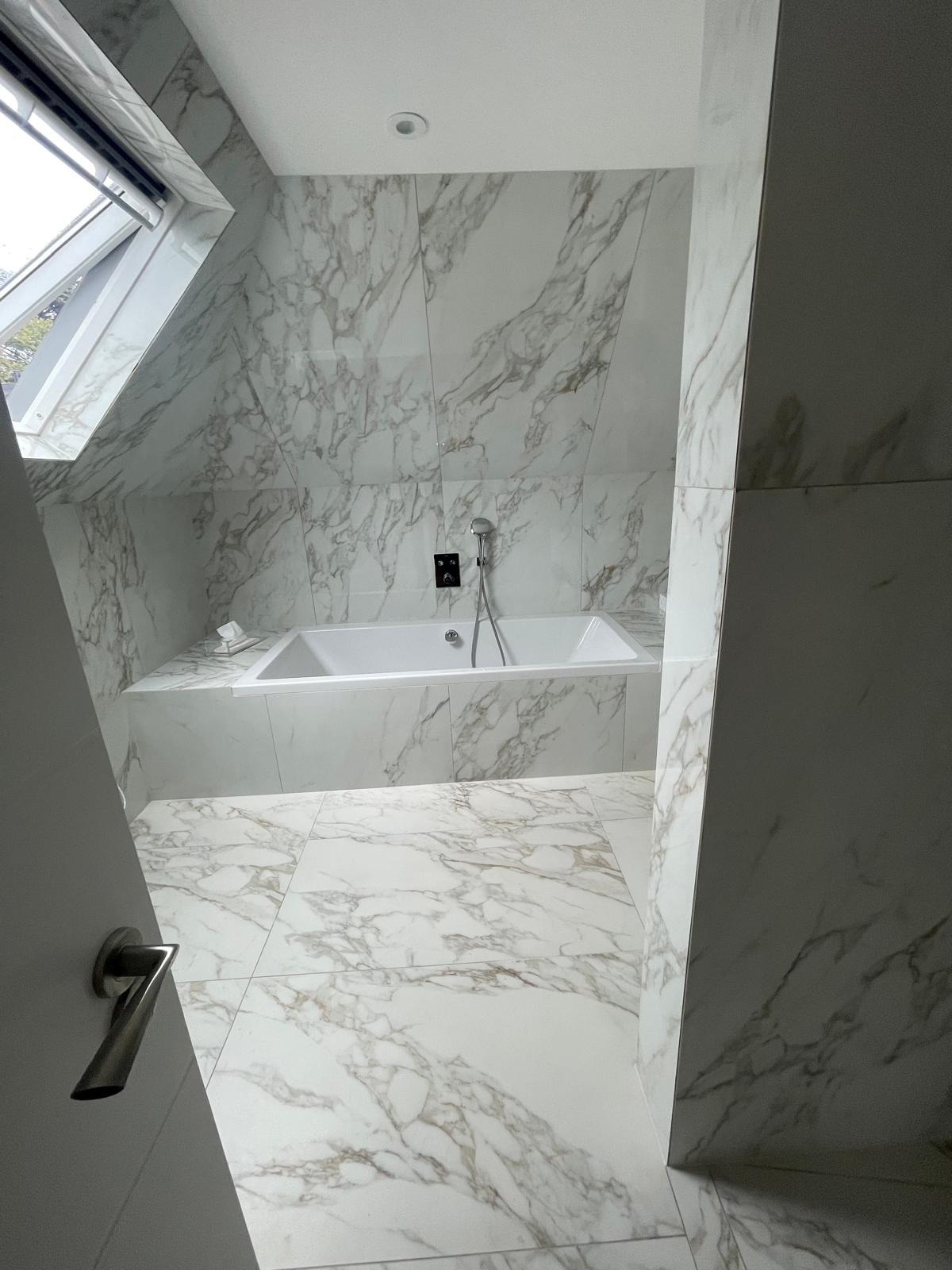 Bathroom renovation featuring new tiles and contemporary fixtures